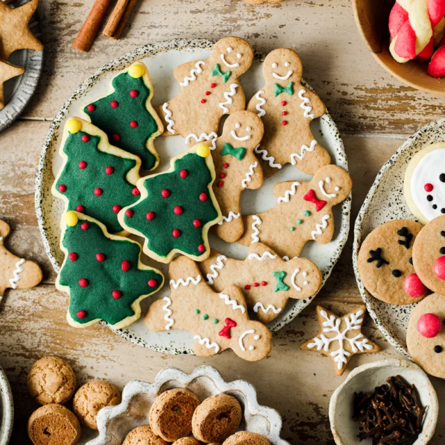 Top view of assorted Christmas cookies on festive table. High angle view of variety fo gingerbread cookies  presented on festive table for Christmas celebration.