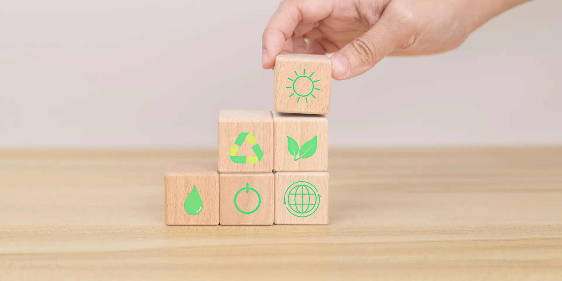 Hand arranging wood block. Recycle symbol Green sun, leaves, water drops, globe, on-off switch on the wooden cube. World environment and earth day. save world concept. taking care nature and ecology.